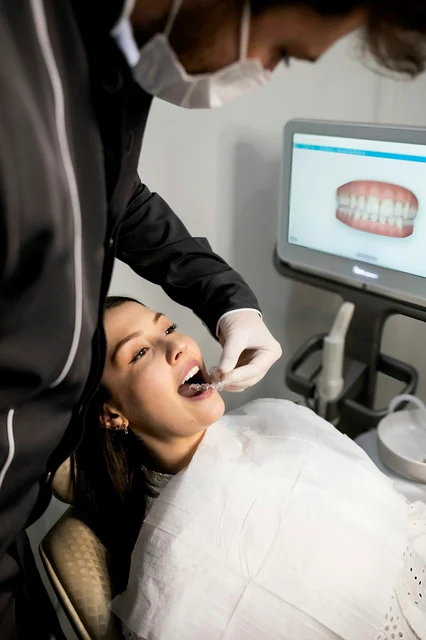 Dentist using a digital intraoral scanner with a patient