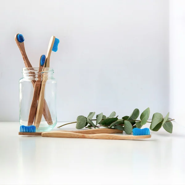 Toothbrushes in a glass jar