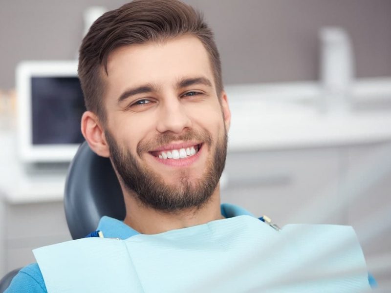smiling-man-in-dental-chair-min